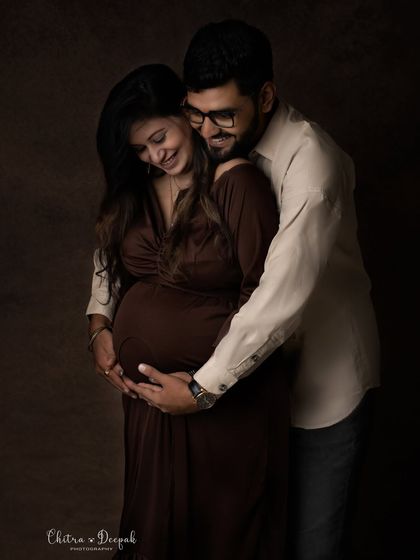 An intimate and candid moment captured in our studio. The genuine smiles and gentle embrace make this photo feel incredibly special.
