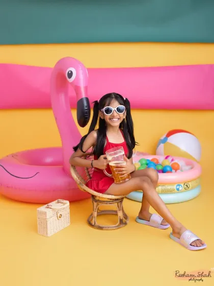 Looking cool and confident with her shades and drink. The bright colors and fun props of the summer theme make every photo pop.