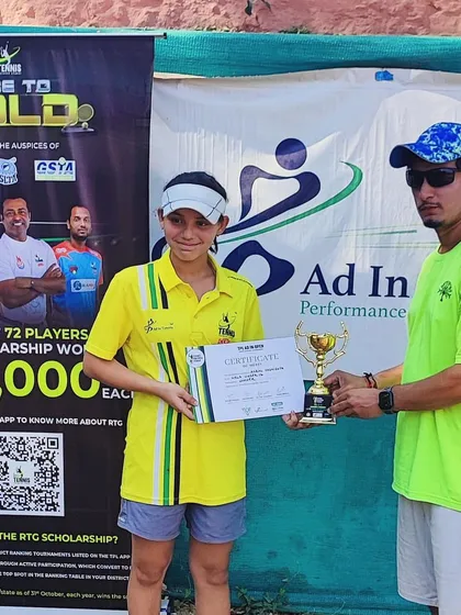 Our U-12 girls' winner receiving her trophy from coach Rahul Belwal.