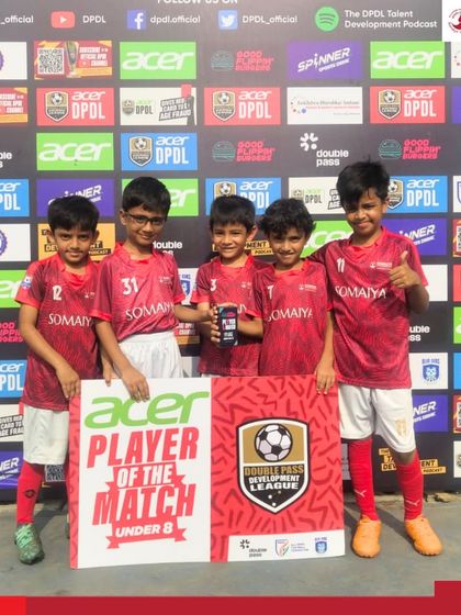 Our Somaiya FC U-8 team poses for a photo after a successful match in the Double Pass Development League, with a player holding the MOTM award.