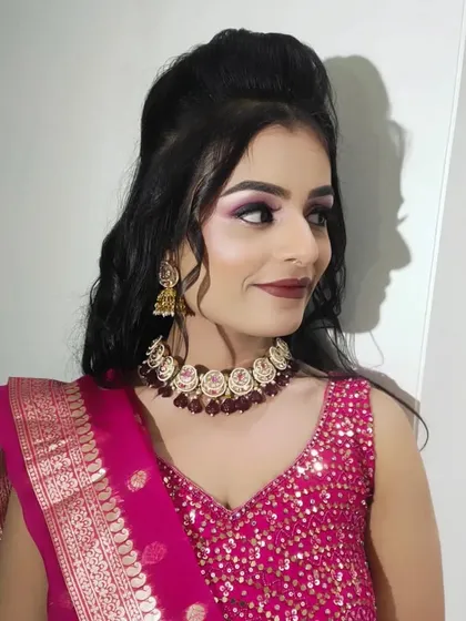 A side view of the sangeet look, showing the high puff hairstyle and the glowing cheekbones.