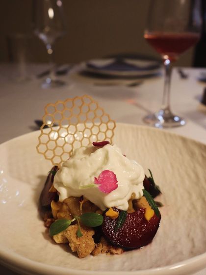 A beautiful vegetarian appetizer featuring roasted beets, creamy cheese, and a honeycomb tuile for sweetness and crunch.