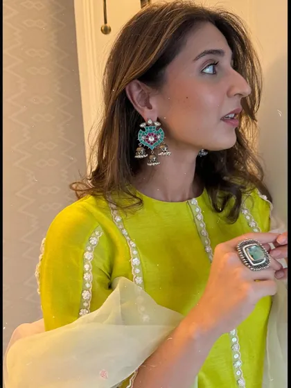A close-up on the beautiful details. Dhvani Bhanushali's look is completed with these stunning multi-colored jhumkas from Sangeeta Boochra.