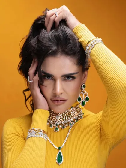 This image combines a bold yellow turtleneck with a stunning emerald and diamond choker. The contrast makes the jewelry pop, showing how I use color theory in my styling to create memorable visuals.