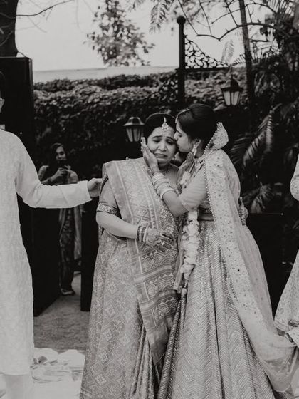 A daughter's farewell kiss to her mother before starting her new life. A poignant and emotional moment captured in black and white.