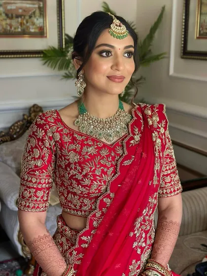 A seated portrait showing the intricate details of her outfit and the soft, radiant makeup. She looks calm, confident, and ready for her big day.