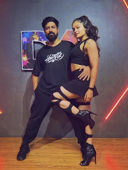 A posed shot with a partner, hinting at a sensual, commercial heels choreography style. I enjoy exploring different genres of dance.