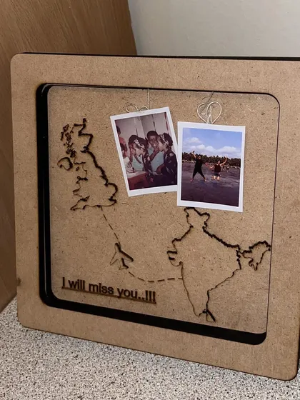 This side view shows the 3D effect of the farewell memory frame. The gap between the glass and the backboard allows for the mini polaroids to hang freely, creating a beautiful shadowbox effect.