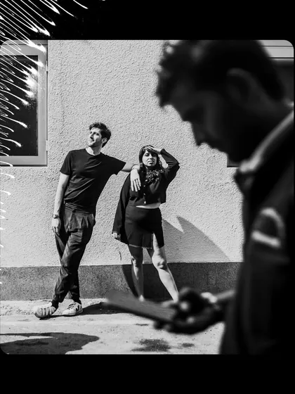 A behind-the-scenes glimpse, this artistic black and white shot has a raw, documentary feel, capturing the creative process of the shoot.