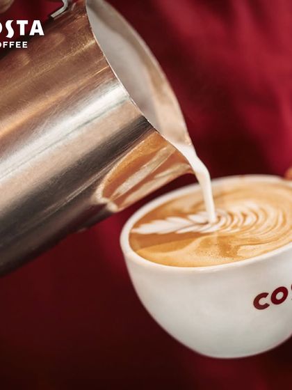 A close-up of a barista creating beautiful latte art in a Costa Coffee cup. This image highlights the craft and quality that goes into every single coffee I serve.