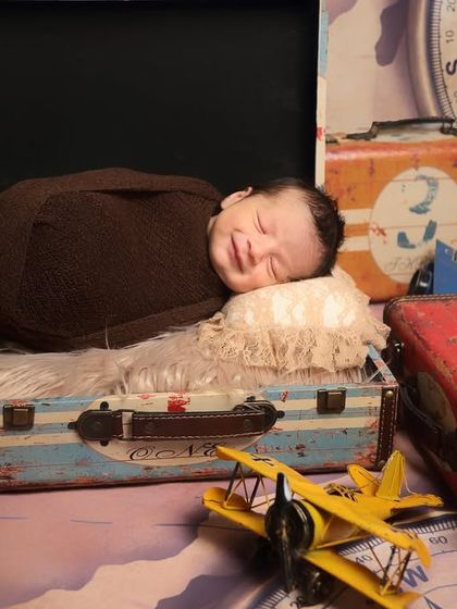 This little traveler is dreaming of adventures. Using vintage suitcases, globes, and toy planes, I created a whimsical travel-themed set for this sleeping newborn.