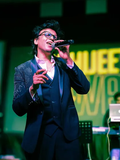 When it's time to suit up, we deliver. Here's singer Abhijeet Sawant looking sharp on stage in one of our embellished tuxedos. This three-piece suit with detailed lapels is perfect for any high-profile performance or formal event.