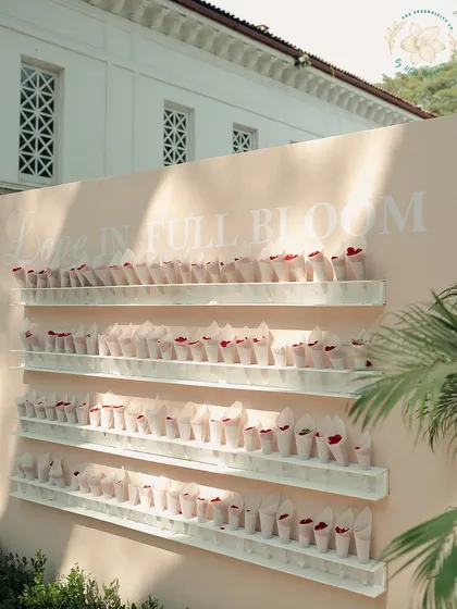 A "Love in Full Bloom" wall, with cones of fresh petals for guests to shower the couple with blessings. It's a small detail that makes for a beautiful, interactive experience.