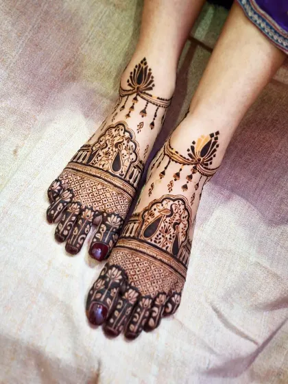 A delicate and beautiful feet mehendi design without human figures, featuring hanging lotus motifs and intricate patterns.