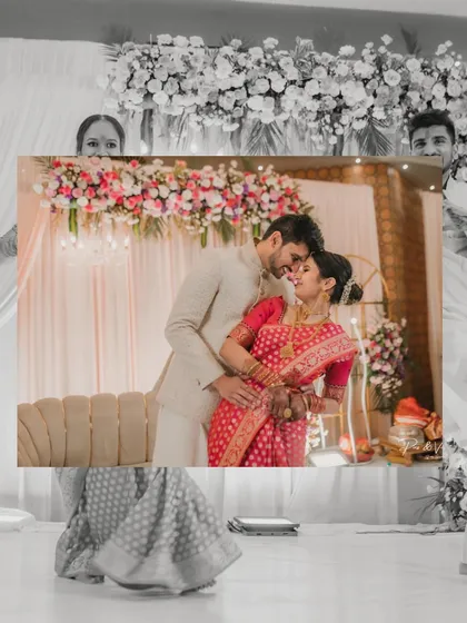 A creative "photo-in-a-photo" shot, where the parents hold up a beautiful portrait of the engaged couple, blending generations of love.