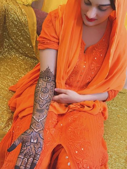 A full-length shot showing how the henna complements the bride's entire look. She is absolutely glowing.