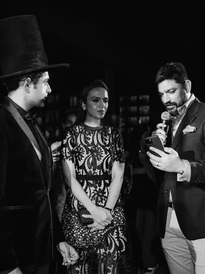 A black and white shot from the Jo Malone event, where I'm interacting with guests. The top hat and formal attire were part of a custom theme designed specifically for the brand's aesthetic.