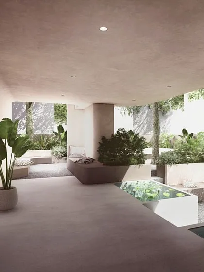 The entrance lobby for "The Nest" is designed as a semi-outdoor space, with planters and a water feature blurring the line between the building and the public landscape. This creates a welcoming, green transition into the private residences.