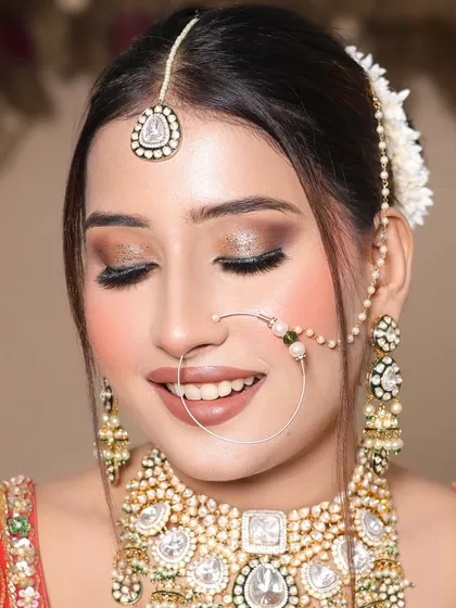 A smiling shot of the bride, showing how the makeup looks natural and beautiful even when expressing emotion. The glitter on the eyes adds a touch of glam.