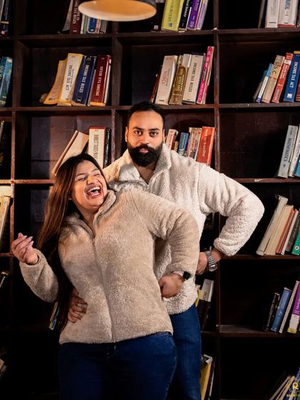 A playful and candid moment in the library, with the couple sharing a laugh. This shows that our indoor sets can be used for both formal and fun-loving portraits.