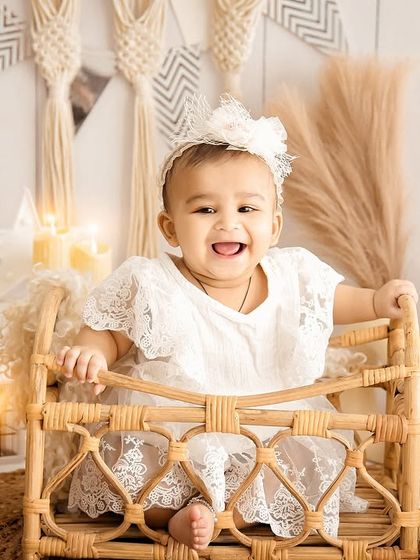 A big, happy smile in a beautiful boho setting. The warm candlelight and natural textures create a cozy and joyful atmosphere.