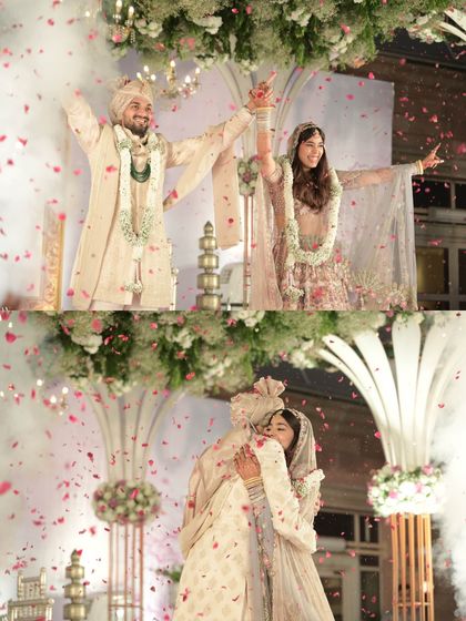 The pure joy of the Varmala ceremony, captured as the couple celebrates under a shower of rose petals on their beautifully decorated stage.
