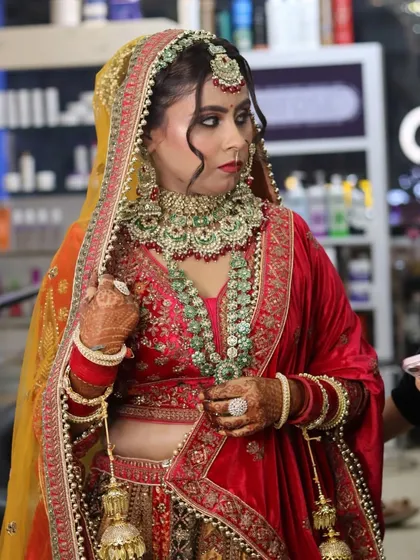 Another angle showcasing the intricate details of the bridal makeup and hair. The side profile highlights the contouring and the carefully placed hair strands that frame the face beautifully.