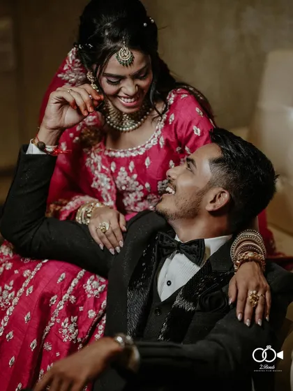 A candid moment of shared laughter between the couple during their glamorous reception. Dressed in their finest, this image captures the joy and elegance of the evening's celebration.