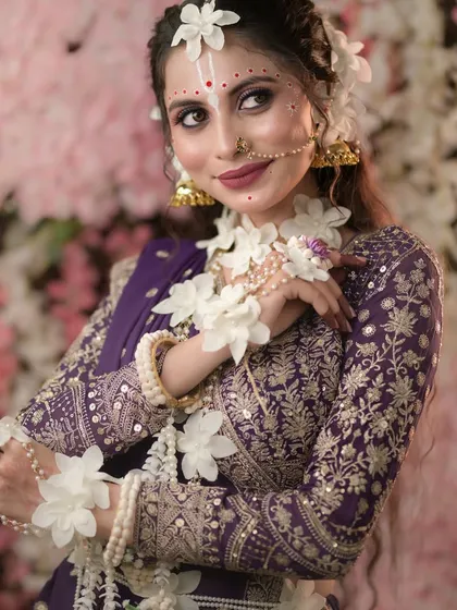 A beautiful portrait from our Radha-themed shoot, highlighting the delicate makeup and floral accessories.