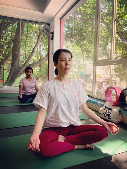 Turning inward. A student sits for meditation, demonstrating the importance of stillness in a complete yoga practice.