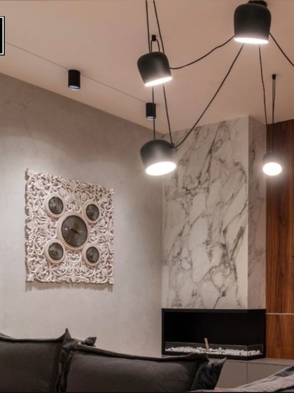 This living room features a dramatic, spider-like pendant fixture that spreads light across the ceiling. It's a bold choice that ensures your happy place is always well-lit and stylish.