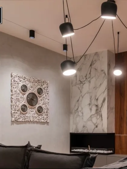 This living room features a dramatic, spider-like pendant fixture that spreads light across the ceiling. It's a bold choice that ensures your happy place is always well-lit and stylish.