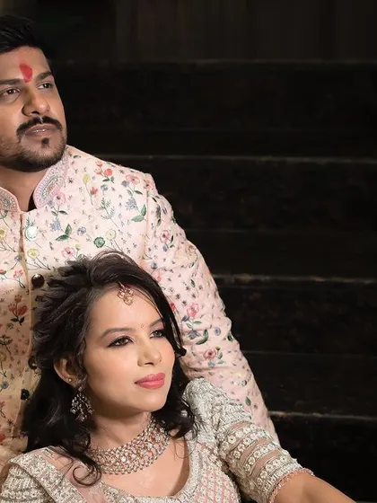 A regal and poised portrait of the couple on their engagement day, seated and looking away, creating a classic and thoughtful image.