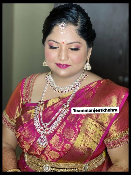 A gorgeous look for a Varapooje ceremony, featuring pink shimmery eyes, a matching lip, and stunning diamond jewellery.