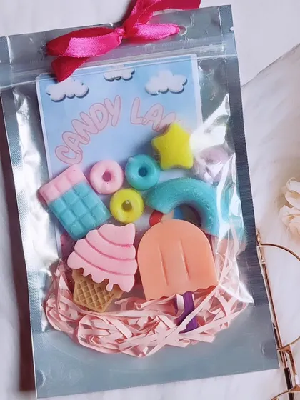 A "Candy Land" themed mini soap set, packaged in a silver pouch, perfect for party favors.