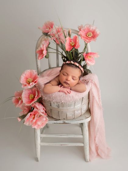 This image demonstrates the use of digital backdrops to expand your creative options. I will show you how to shoot the baby in a prop and then seamlessly blend them into a pre-made scene like this floral chair setup.