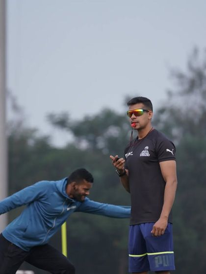 An athlete powers through a resisted lateral lunge. This drill builds strength and power in the frontal plane, which is crucial for defensive movements and evading tackles.