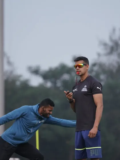 An athlete powers through a resisted lateral lunge. This drill builds strength and power in the frontal plane, which is crucial for defensive movements and evading tackles.