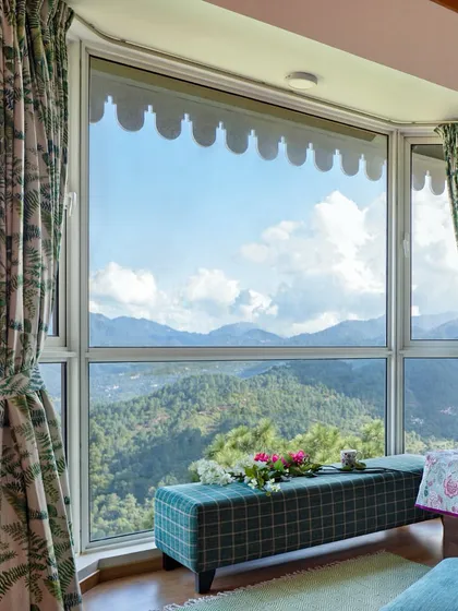 For us, the greatest luxury is a connection to nature. In this Kasauli mountain home, we designed the master bedroom's bay window not just as a feature, but as a destination for quiet contemplation, offering uninterrupted views of the Himalayan valley.