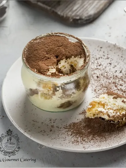My classic Tiramisu served in a jar. This presentation showcases the beautiful layers of coffee-soaked ladyfingers and mascarpone cream, finished with a dusting of cocoa.