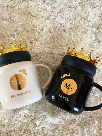 Another view of our popular "Mr. Right" and "Mrs. Always Mine" mugs with their signature crown lids. These are perfect for adding a playful and romantic touch to any gift.