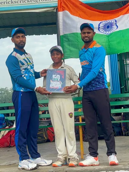 Another shot of Rudraksh with his award, standing tall with his coaches.