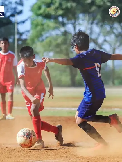 An action shot of Swarit Satpute shielding the ball from an opponent during a competitive state league match.