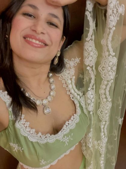 A happy selfie showing off the details of the pastel green lehenga and the complementary jewelry. It's all about creating a look that makes you feel confident and joyful.