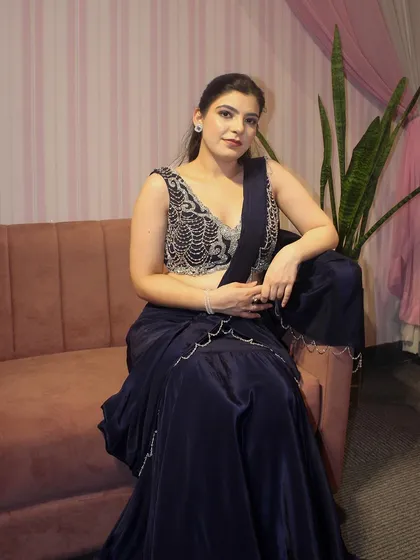 A shot of me modeling our navy blue draped sharara set. The satin fabric has a beautiful sheen and feels incredibly luxurious.