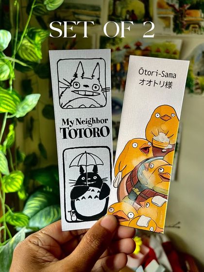 A set of two bookmarks featuring Totoro and the Otori-Sama. These are printed on high-quality textured paper.