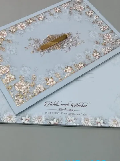 This invitation features a soft blue floral pattern on the cover and matching inserts. The design is clean and fresh, ideal for a spring or summer wedding.