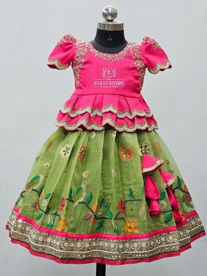 A Zari Kota lehenga with a bird-print skirt. The pink blouse has a tiered peplum and is heavily embroidered.