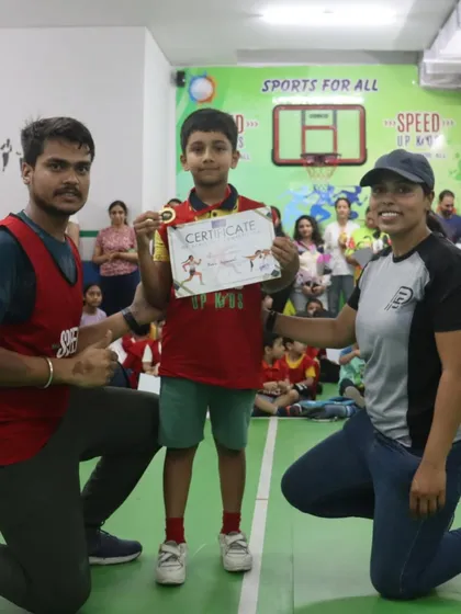 A young athlete receives his medal and certificate at our athletics competition. A proud moment for him and his coaches.