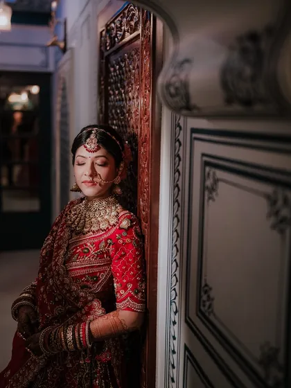 Sometimes the most powerful moments are the quiet ones. I took this portrait of Khyati just before her ceremony, a serene moment of reflection. My photography focuses on capturing both the grand celebration and the bride's inner emotions.